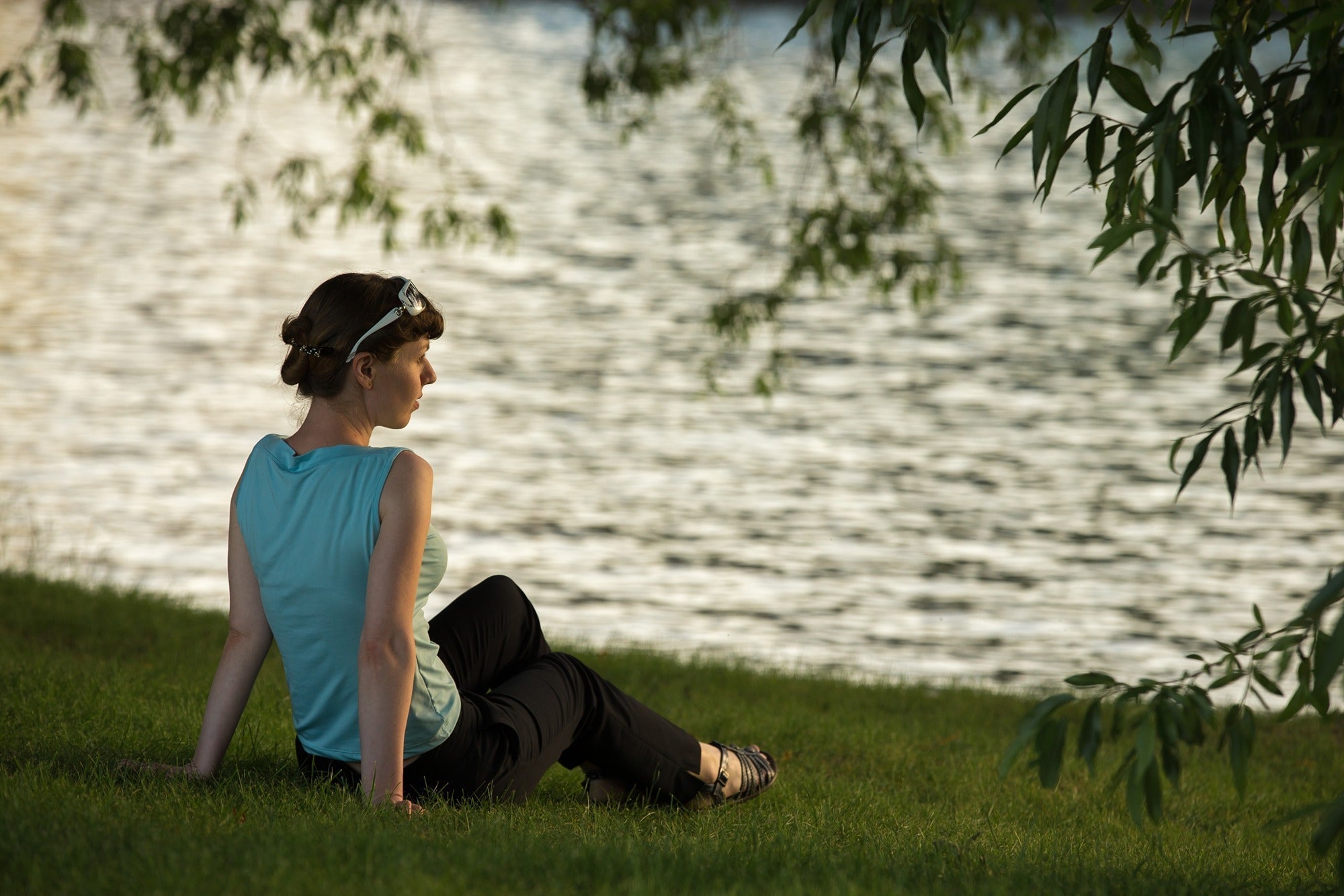 Person practicing mindfulness outdoors during a sunny summer day.